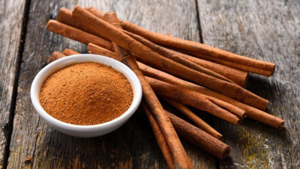 bowl of ready-to-use ground cinnamon and a few pieces of whole cinnamon