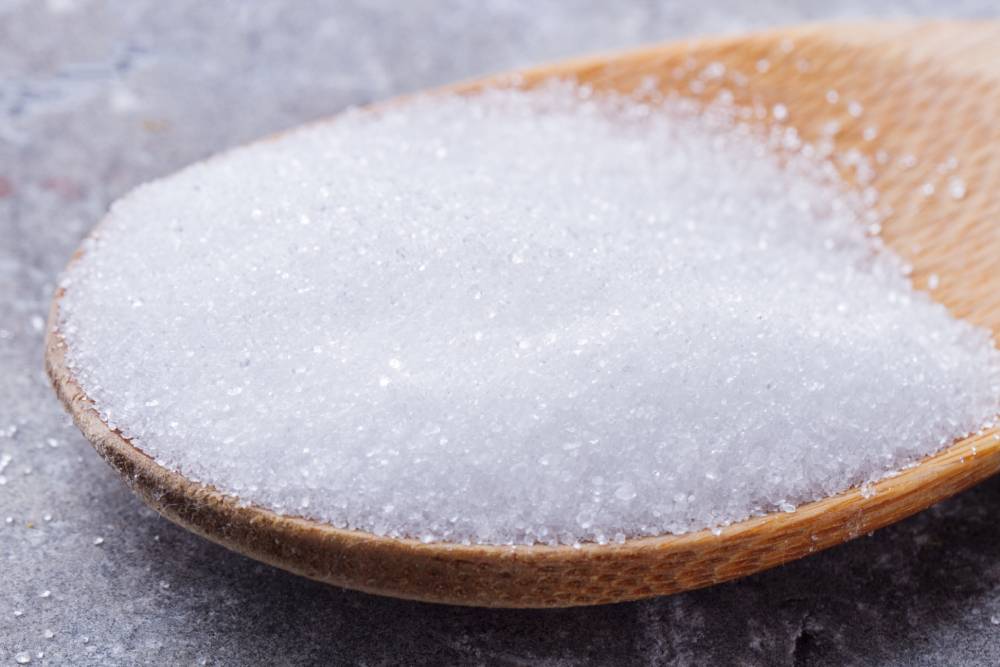 Erythritol or sugar on spoon