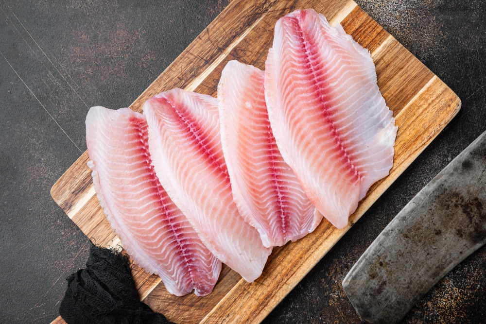 Raw tilapia fillets on the cutting board