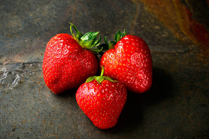 three pieces of fresh strawberries on the table