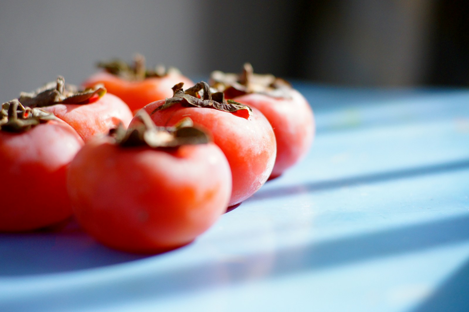 red persimmon on blue table